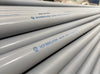 A close-up view of multiple light gray irrigation pipes stacked diagonally, with blue printed text reading 'AGS IRRIGATION Lead free' marking visible on the surface.
